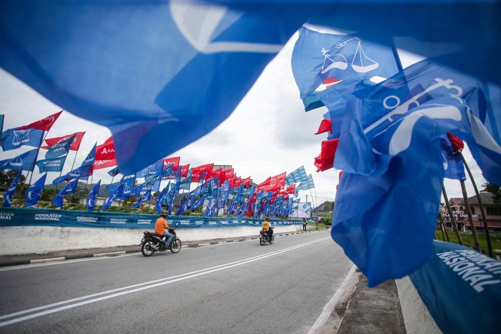 The 'Flag War' with BN, Pakatan and PN banners are seen during at Kg Gugusan Manjoi, Tambun. — Picture by Farhan Najib