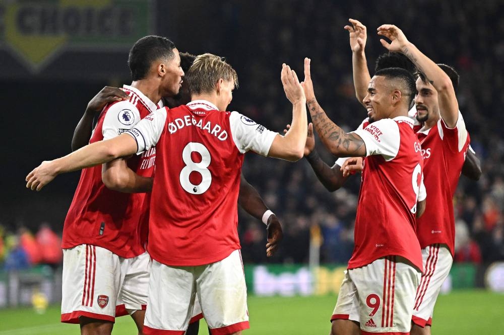Arsenal's Norwegian midfielder Martin Odegaard celebrates scoring his team's second goal with teammates during the English Premier League football match between Wolverhampton Wanderers and Arsenal at the Molineux stadium in Wolverhampton, central England on November 12, 2022. — AFP pic