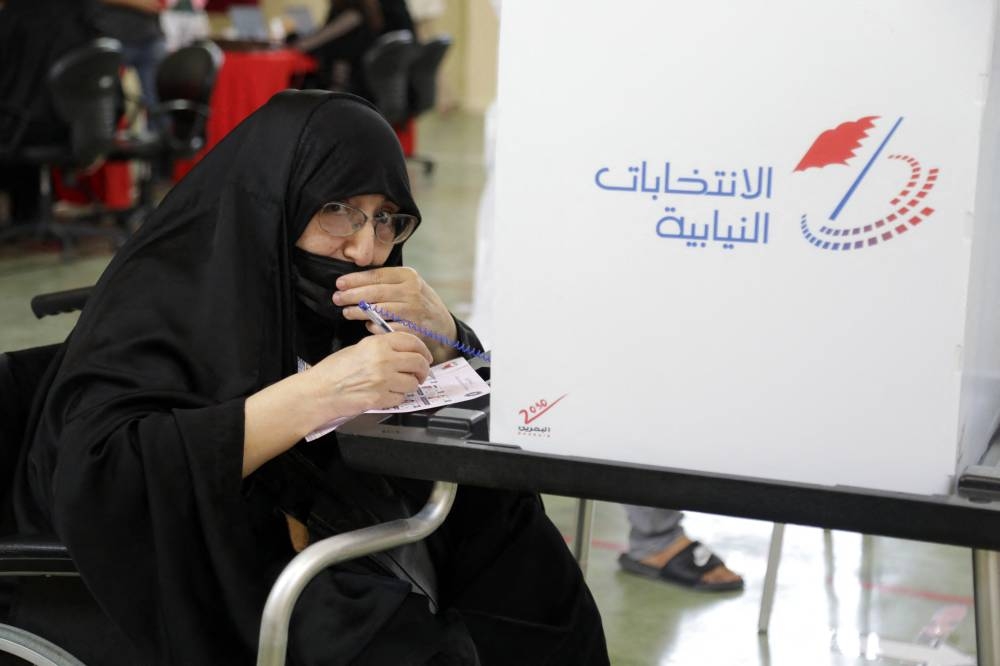 An elderly Bahraini woman prepares her ballot at a polling station in the city of Jidhafs, about 3km west of the capital Manama, during parliamentary elections, on November 12, 2022. — AFP pic