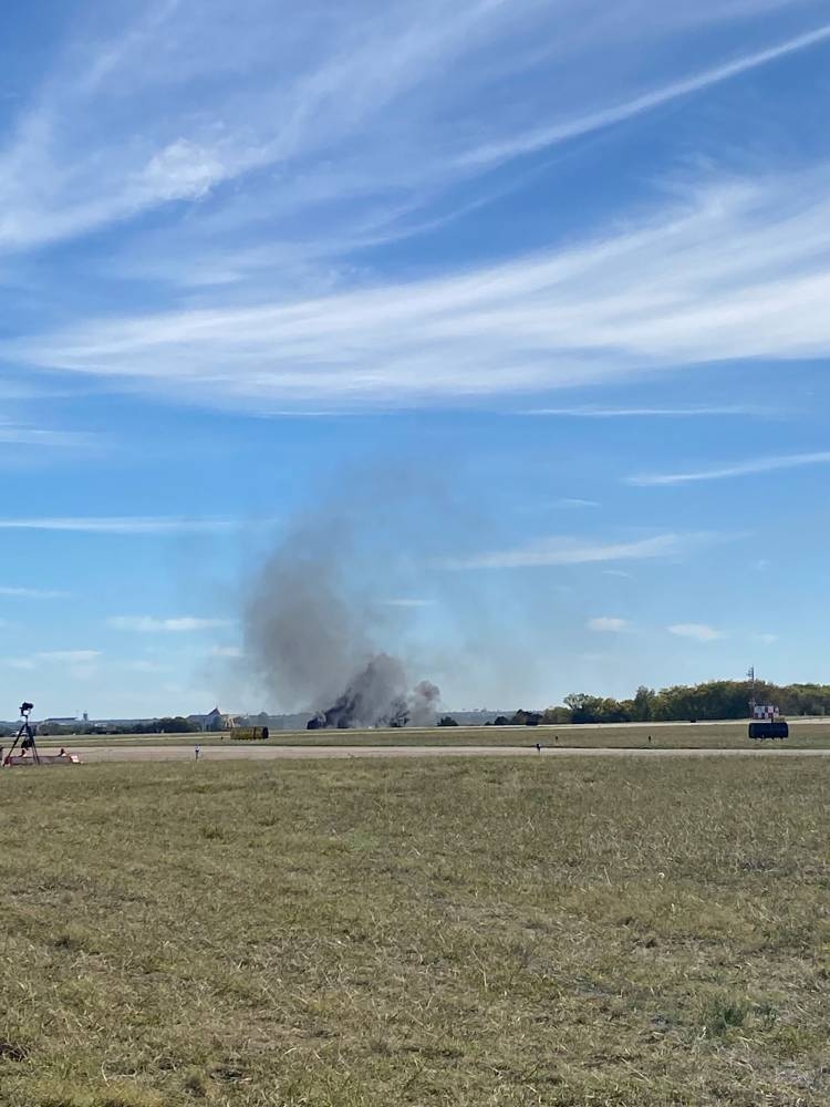 This image obtaimned from the twitter account @GollyItsMollie, shows smoke rising from the crash after two planes collided mid-air during the Wings Over Dallas Airshow at Dallas Executive Airport, in Dallas, Texas, on November 12, 2022. — @GollyItsMollie handout pic via AFP