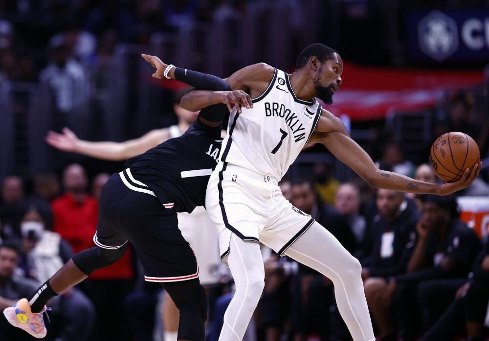 Kevin Durant #7 of the Brooklyn Nets is fouled by Reggie Jackson #1 of the LA Clippers in the second half at Crypto.com Arena on November 12, 2022 in Los Angeles, California. — Ronald Martinez/Getty Images/AFP pic