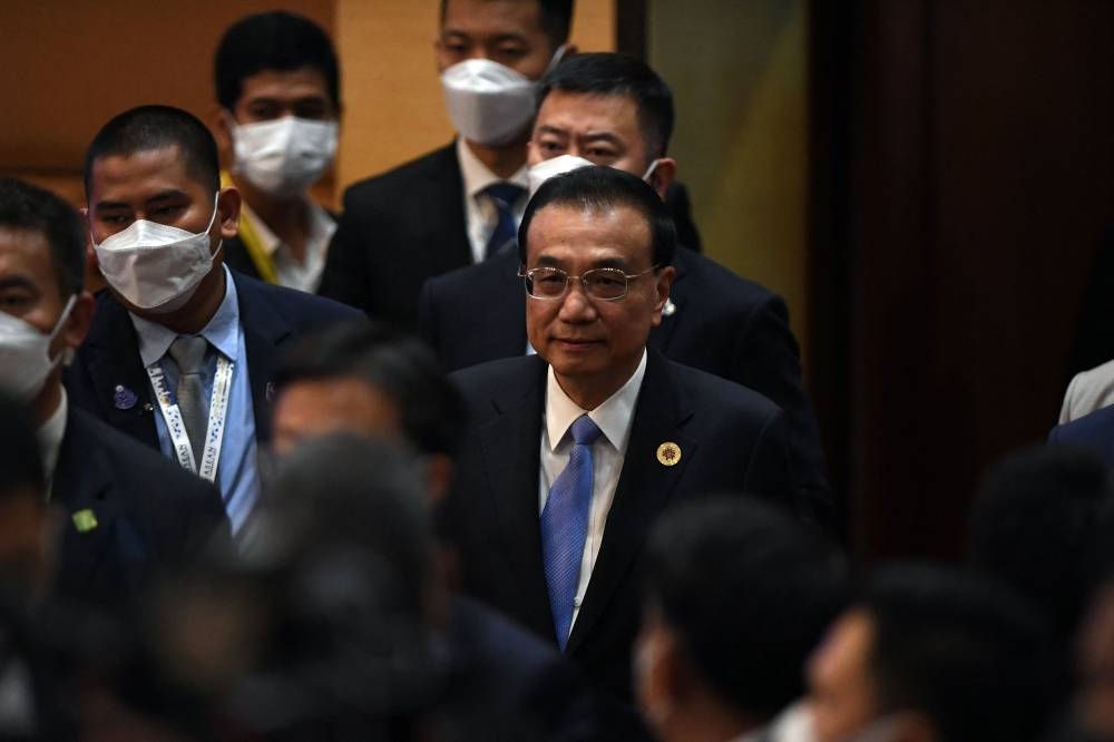 China’s Prime Minister Li Keqiang (centre) arrives for the East Asia Summit as part of the 40th and 41st Association of Southeast Asian Nations (Asean) Summits in Phnom Penh on November 13, 2022. — AFP pic