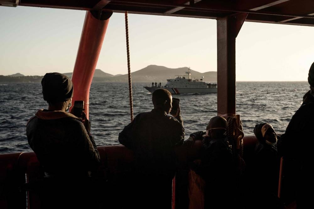 Migrants stand on board the Ocean Viking prior disembarking in Toulon on November 11, 2022, after being rescued by European maritime-humanitarian organisation ‘SOS Mediterranee’. — AFP pic