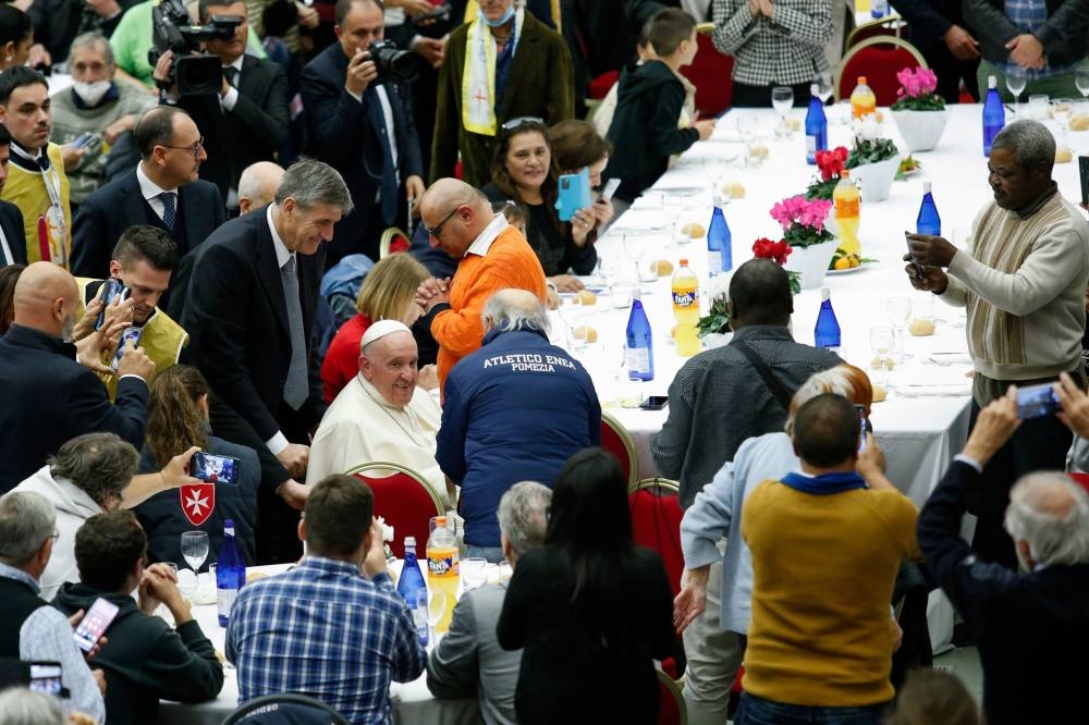 Pope Francis participates in a lunch offered by the Vatican to the poor people, on World Day of Poor at the Vatican, November 13, 2022. — Reuters pic
