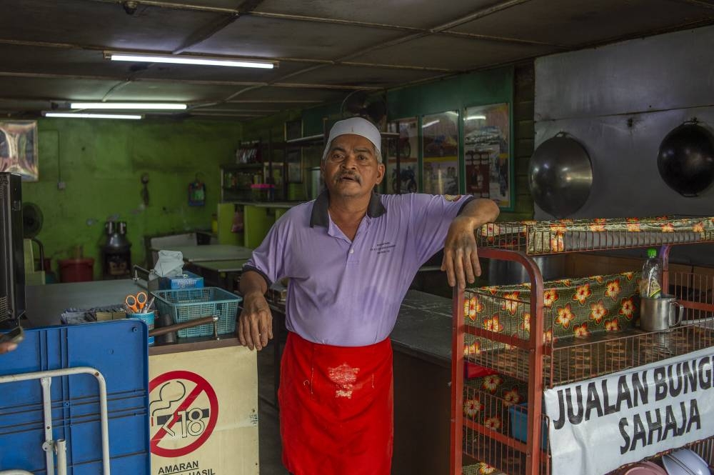 Abdul Wahab stands at the entrance of his stall that sells oxtail soup.