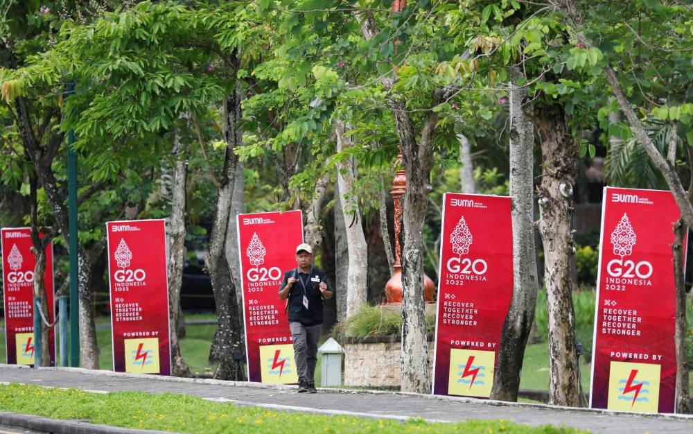A man walks past banners ahead of the G20 summit in Nusa Dua, Bali, Indonesia, November 13, 2022. — Reuters pic