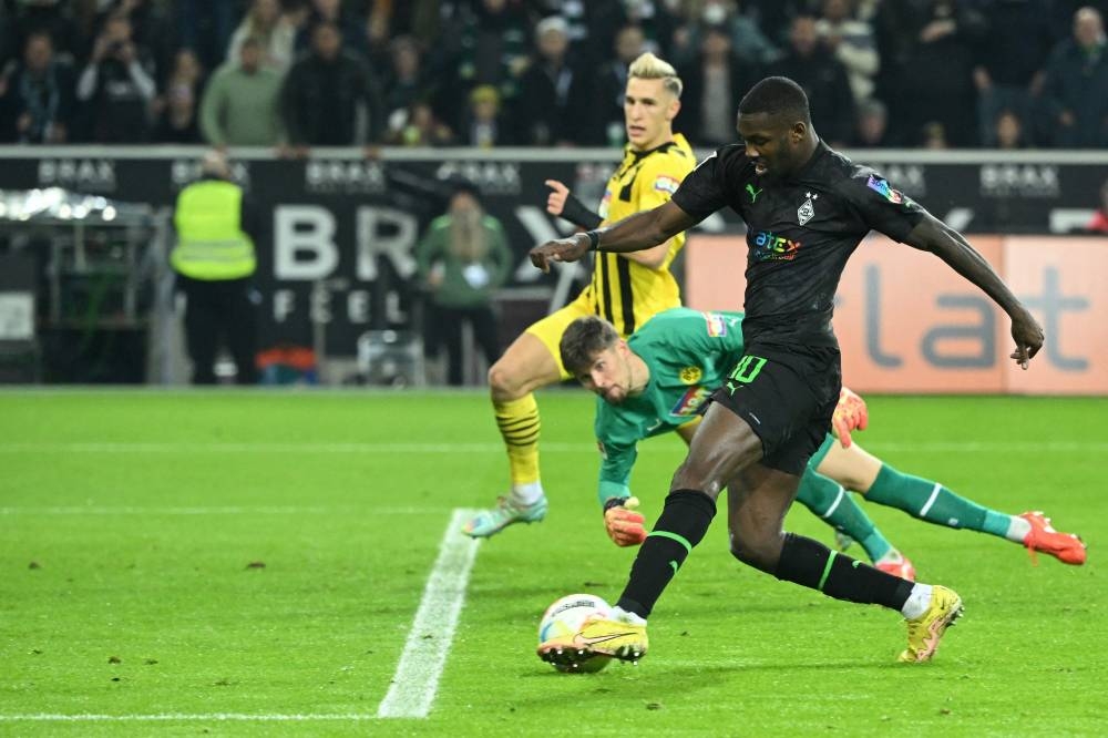 Moenchengladbach’s French forward Marcus Thuram shoots to score a goal during the German first division Bundesliga match between Borussia Moenchengladbach v Borussia Dortmund in Moenchengladbach, western Germany, November 11, 2022. — AFP pic 