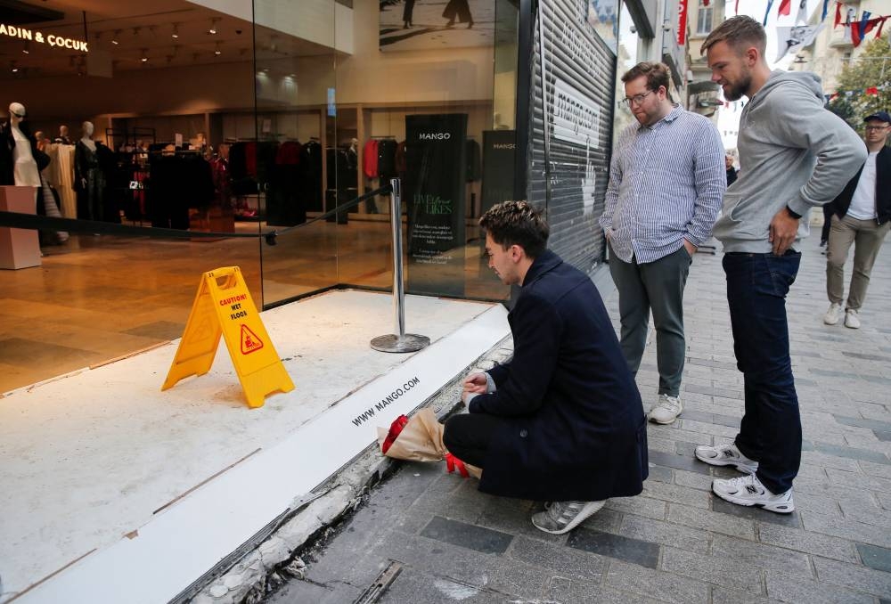 A man lays flowers to pay tribute to the victims of yesterday’s blast that took place on Istiklal Avenue, a popular spot for shoppers and tourists, in Istanbul, Turkey, November 14, 2022. — Reuters pic
