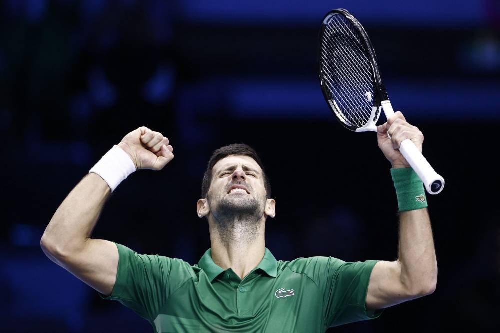 Serbia's Novak Djokovic celebrates after winning his group stage match against Greece's Stefanos Tsitsipas in Turin November 14, 2022. — Reuters pic