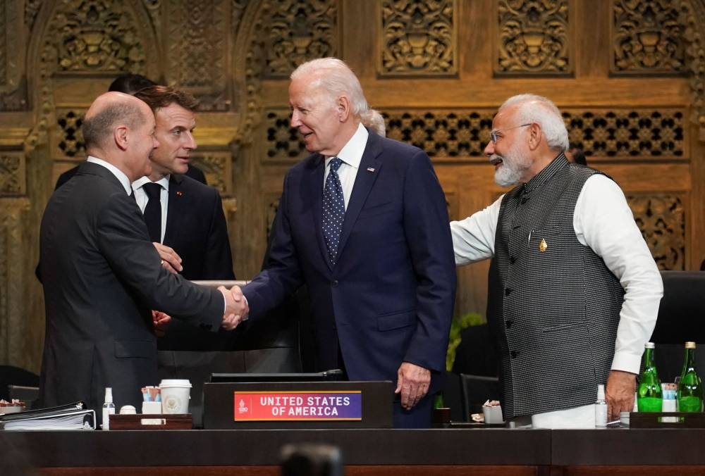 US President Joe Biden, France’s President Emmanuel Macro, Germany’s Chancellor Olaf Scholz and India’s Prime Minister Narendra Modi greet each other during the first working session of the G20 leaders’ summit in Bali November 15, 2022. — Reuters pic