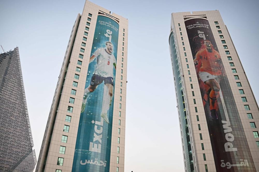 Banners depicting England’s captain Harry Kane (left) and the Netherlands’ captain Virgil van Dijk displayed on buildings in Doha, November 13, 2022 ahead of the Qatar 2022 World Cup. — AFP pic 