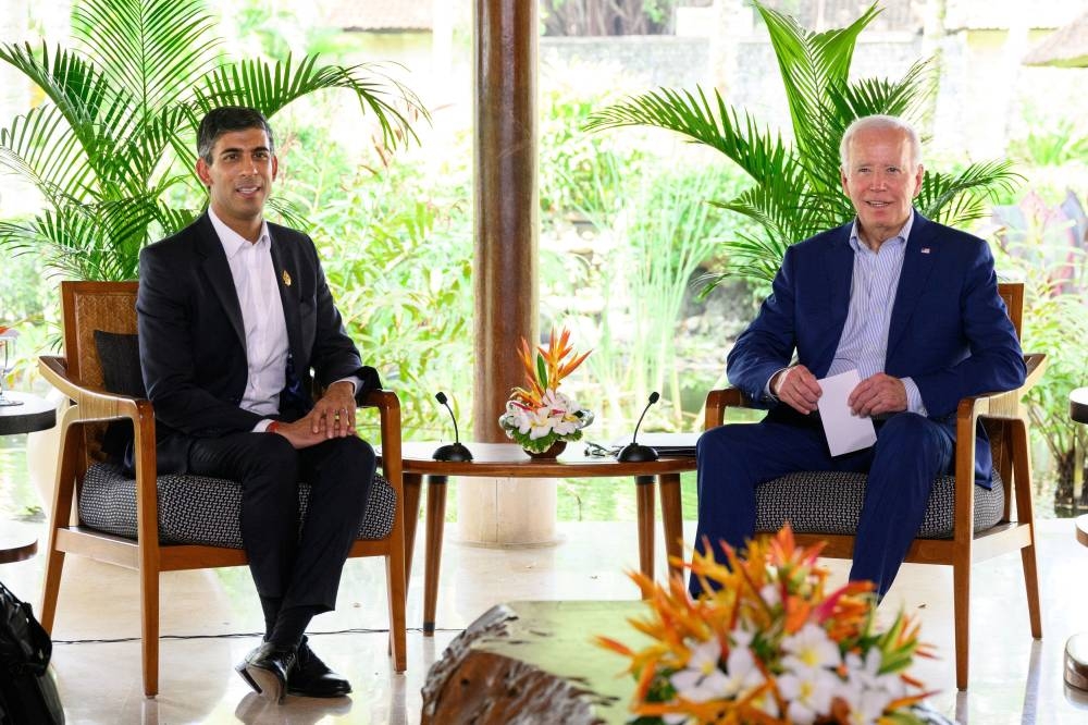 British Prime Minister Rishi Sunak (left) speaks with US President Joe Biden during a bilateral meeting at the G20 summit in Nusa Dua, Indonesia November 16, 2022. — Reuters pic