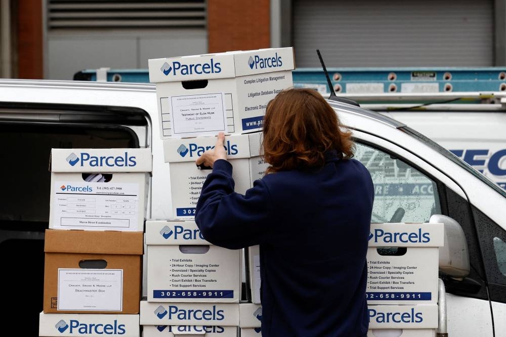 A person transports boxes with documents for the trial of Elon Musk, Chief Executive Officer (CEO) of SpaceX, Tesla and Twitter, regarding his Tesla pay package at the Delaware Court of Chancery in Wilmington, Delaware November 16, 2022. — Reuters pic
