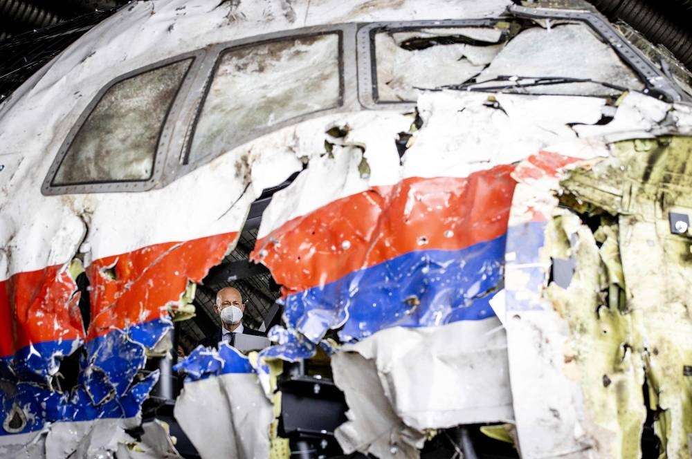 In this file photo taken on May 26, 2021, presiding judge Hendrik Steenhuis views the reconstructed wreckage of Malaysia Airlines Flight MH17, at the Gilze-Rijen military airbase, southern Netherlands. — AFP pic