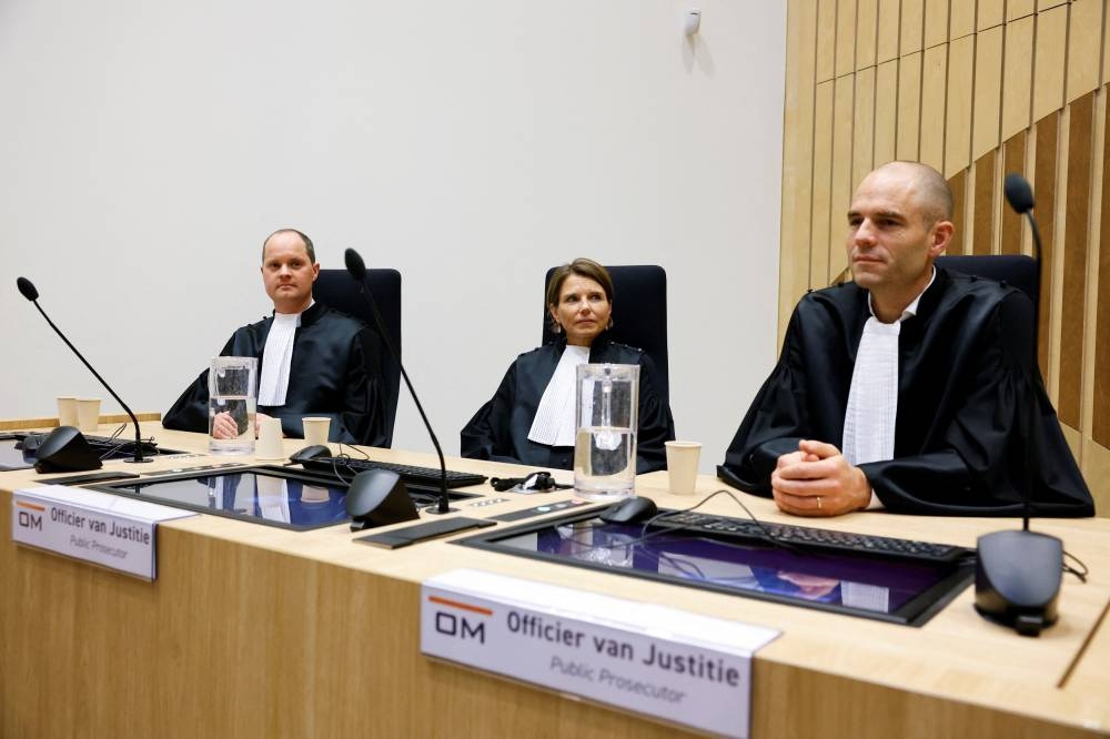 Public prosecutors Ward Ferdinandusse, Manon Ridderbeks, and Thijs Berger sit in the courtroom as the Dutch court announces its ruling in the MH17 trial of three Russians and a Ukrainian in the Schiphol Judicial Complex, Badhoevedorp, Netherlands, November 17, 2022. — Reuters pic