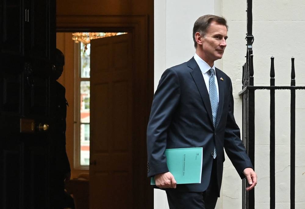 Britain's Chancellor of the Exchequer Jeremy Hunt walks out of Number 11 Downing Street in central London on his way to make a full budget statement in the House of Commons on November 17, 2022. — AFP pic