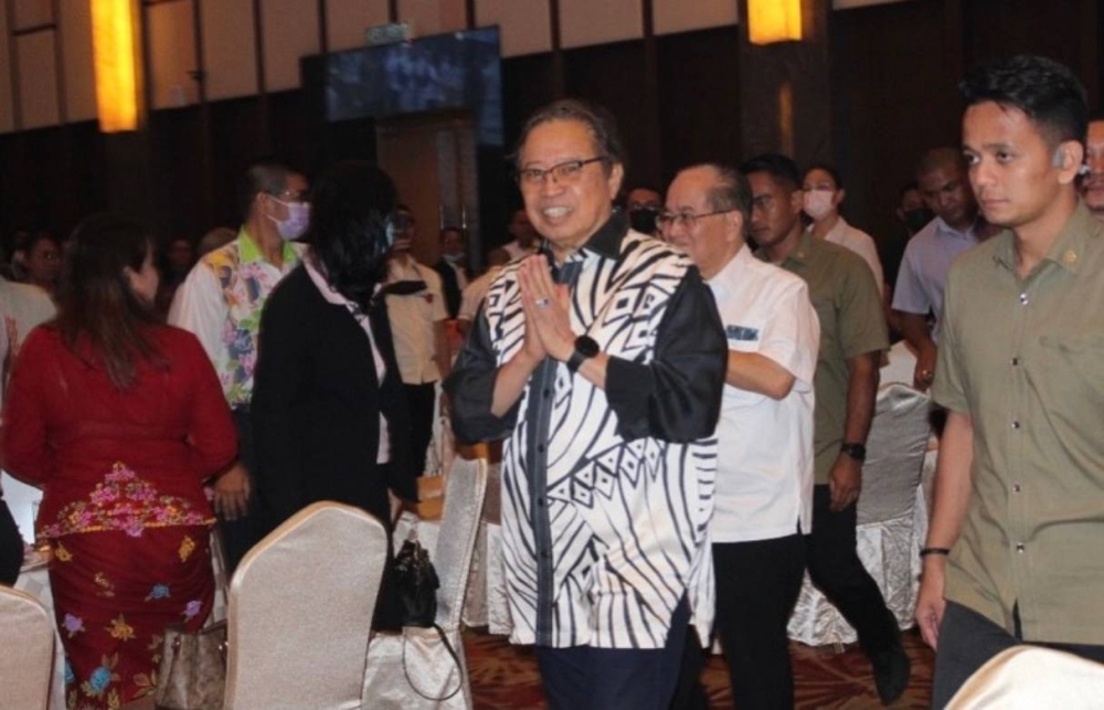 Abang Johari gestures upon arrival for the event. Uggah is seen behind him. — Ukas pic via Borneo Post