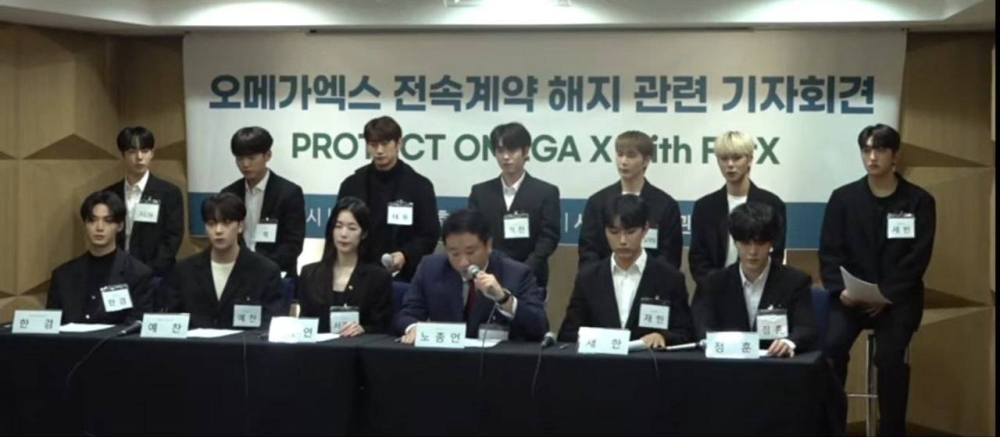 K-pop group Omega X with their legal representatives at a press conference in Seoul. — Screenshot via YouTube/ TV1Ten