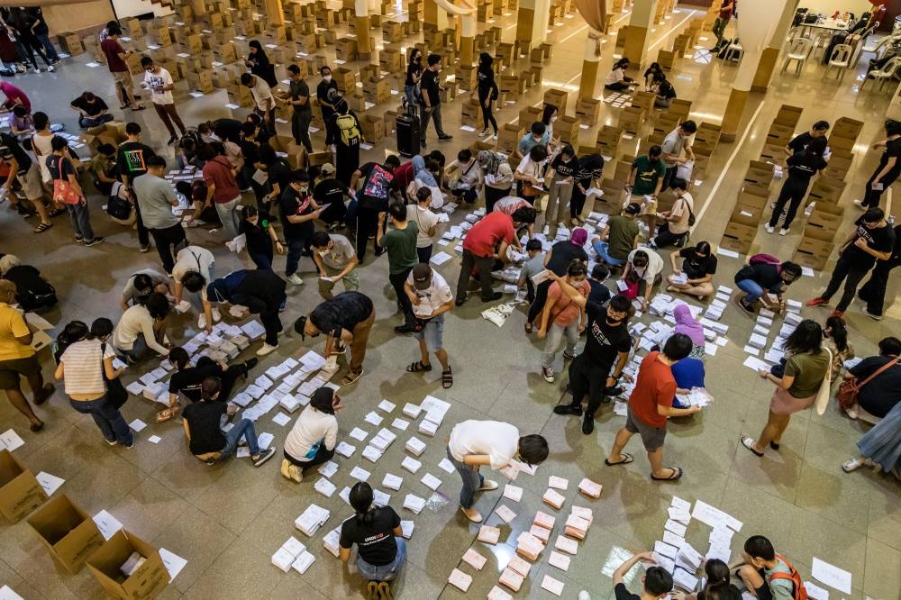 Volunteers sorting out postal votes according to their constituencies in conjunction with polling day for the 15th general election, November 18, 2022. — Picture by Firdaus Latif