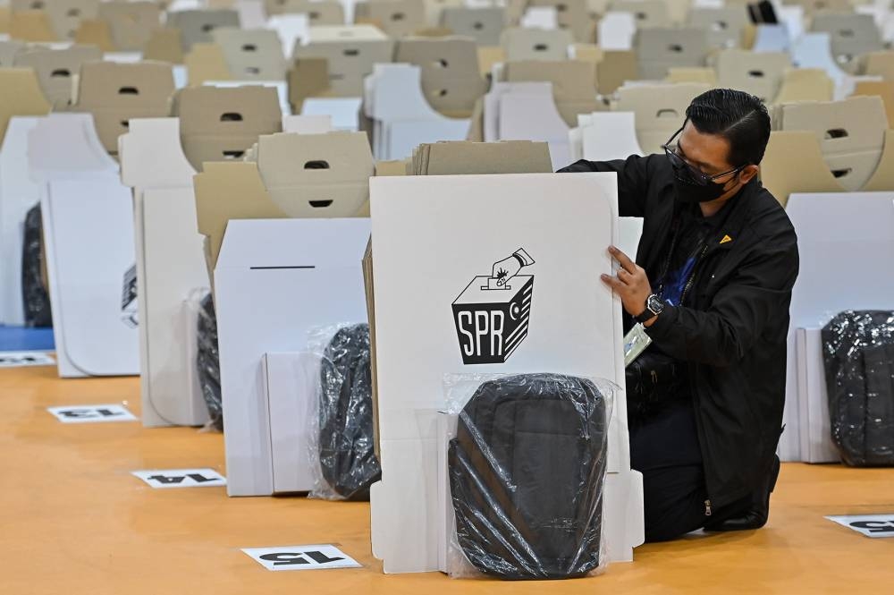 Election Commission workers are seen preparing ballot boxes ahead of the 15th general election in Shah Alam, November 18, 2022. — Picture by Miera Zulyana