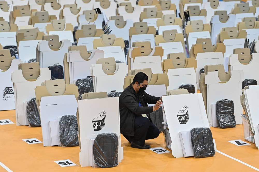 Election Commission workers are seen preparing ballot boxes ahead of the 15th general election at Shah Alam, November 18, 2022. — Picture by Miera Zulyana