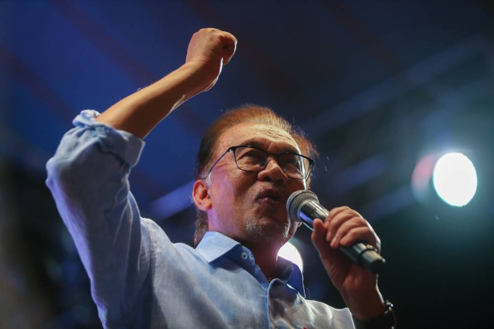 Datuk Seri Anwar Ibrahim gestures while delivering a political speech at Meow Garden in Tambun on November 18,2022. — Picture by Ahmad Zamzahuri
