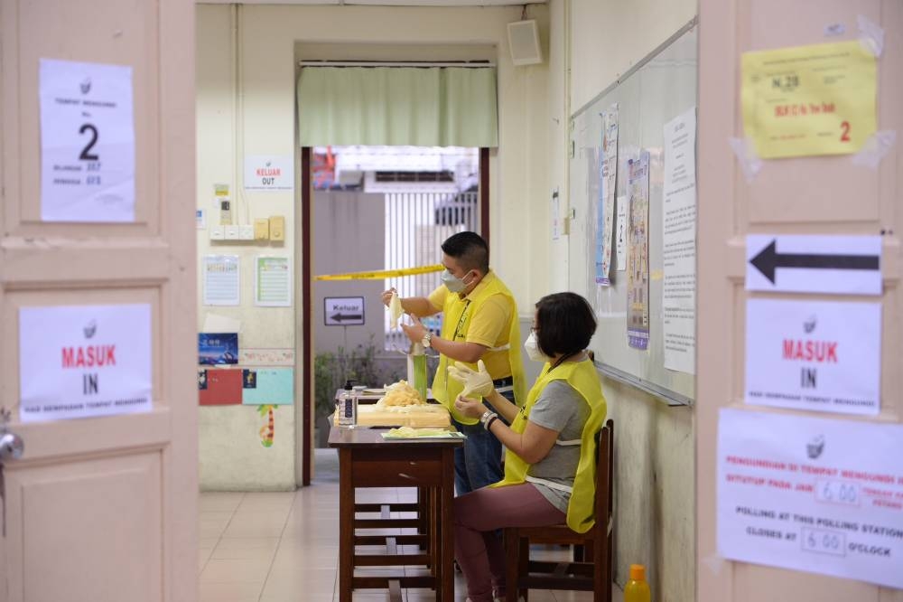 Election Commission personnel preparing the polling station for the 15th general election in George Town, Penang November 19, 2022. ― Picture by Steven KE Ooi