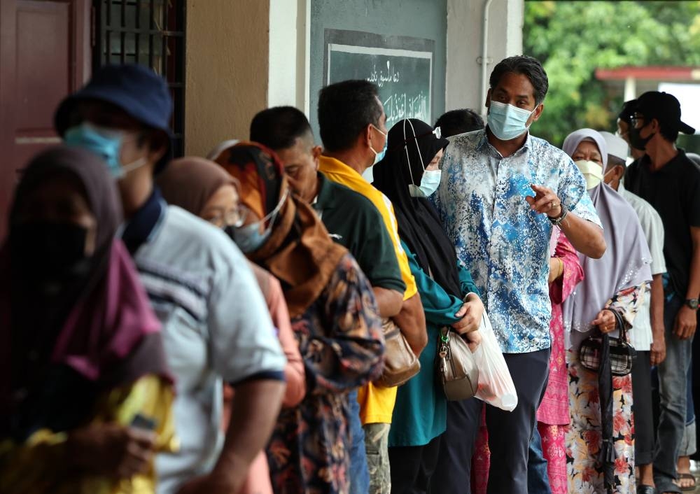 Barisan Nasional’s candidate for the Sungai Buloh Parliamentary seat and caretaker health minister Khairy Jamaluddin greets fellow voters at the polling station located at Sekolah Menengah Agama Hj. Mohd Yatim in Rembau November 19, 2022. — Bernama pic
