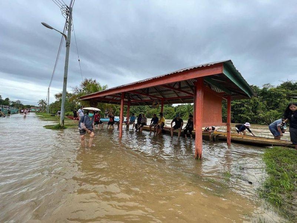 People wade through floodwaters in Baram November 19, 2022. — Picture via Facebook