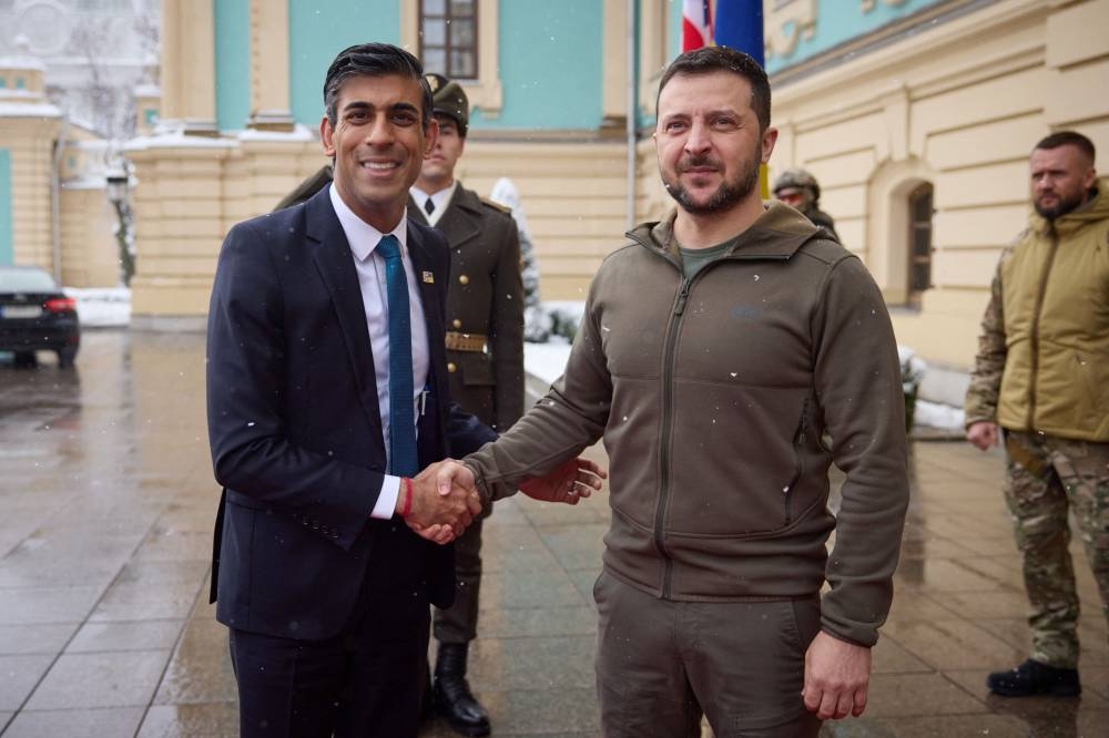 This handout picture taken and released by the Ukrainian presidential press service on November 19, 2022, shows Ukrainian President Volodymyr Zelensky (right) shakes hands with British Prime Minister Rishi Sunak (left) prior to their meeting in Kyiv, amid Russia’s invasion of Ukraine. — AFP pic