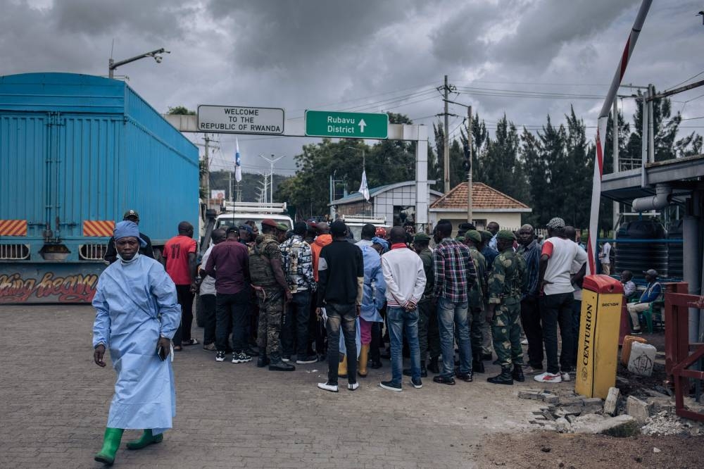 Congolese security officers gather around a team of investigators from the International Conference on the Great Lakes Region’s (ICGLR) Expanded Joint Verification Mechanism in the no-man’s-land between Rwanda and the Democratic Republic of Congo at the Petite Barrie border post in Goma on November 19, 2022. — AFP PIC