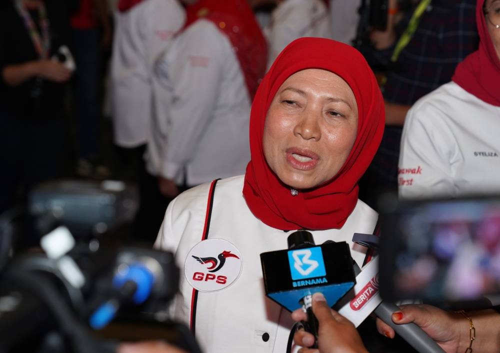 Nancy is met by reporters at BCCK last night. — Borneo Post pic