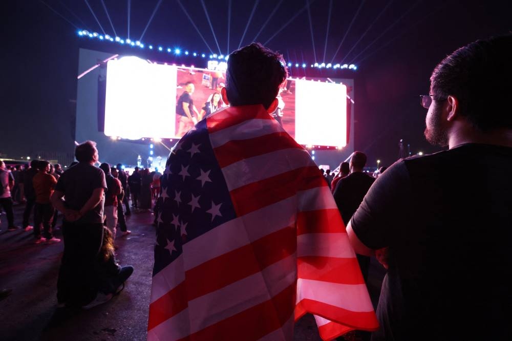A United States fan is seen watching the match between United States and Wales at the Al Bidda Park, Doha November 21, 2022. — Reuters pic