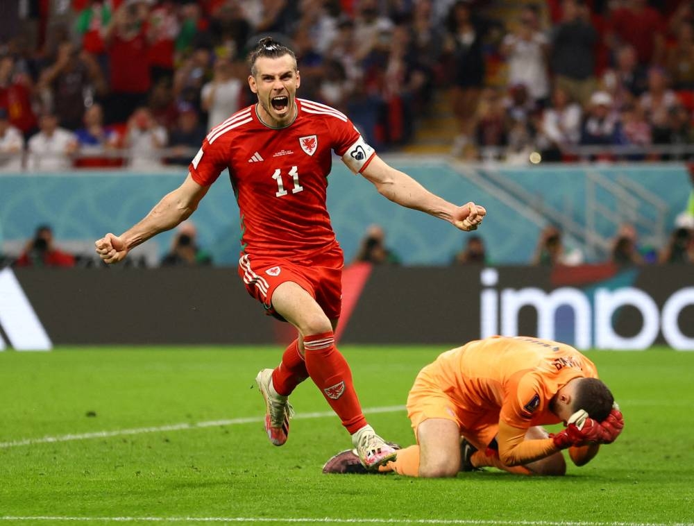 Wales' Gareth Bale celebrates scoring their first goal against the United States at the Ahmad Bin Ali Stadium, Al Rayyan November 21, 2022. — Reuters pic