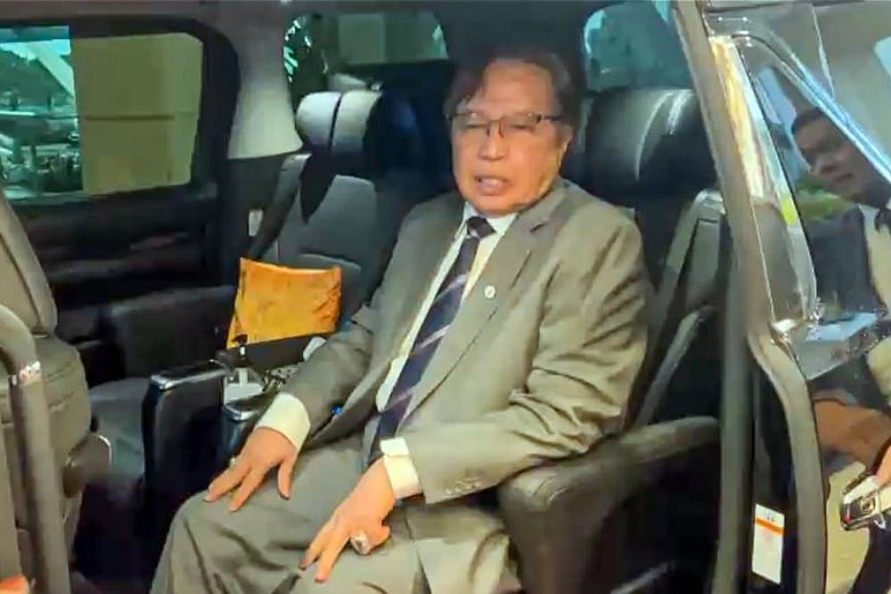 Sarawak Premier Tan Sri Abang Johari Openg leaving the DUN complex after being met by reporters today. — Borneo Post pic 