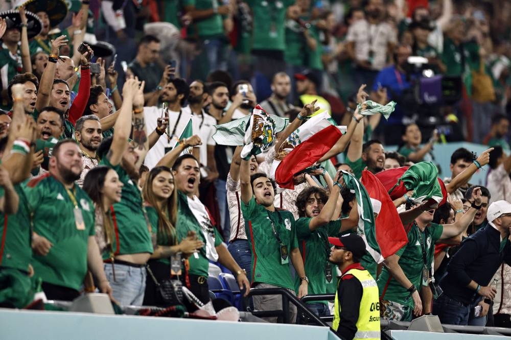 Mexico fans celebrate after Guillermo Ochoa saved a penalty from Poland's Robert Lewandowski at Stadium 974, Doha November 22, 2022. — Reuters pic