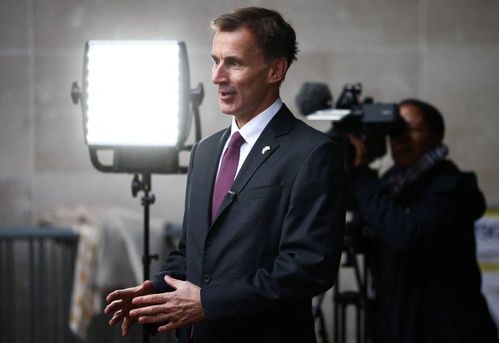 British Chancellor of the Exchequer Jeremy Hunt talks to a television crew outside the BBC headquarters in London November 18, 2022. — Reuters pic