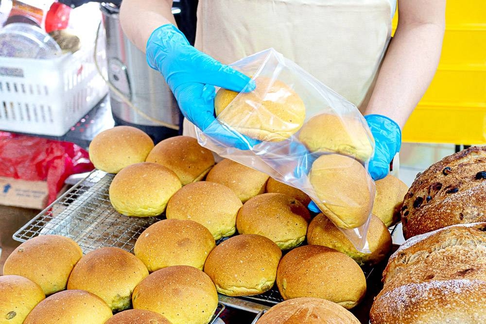Packing freshly baked buns for customers.