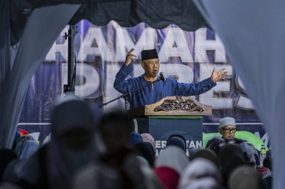 PN chairman Tan Sri Muhyiddin Yassin and PAS president Tan Sri Abdul Hadi Awang’s claim that PH was colluding with Jews and Christians also significantly influenced conservative voters. — Picture by Hari Anggara