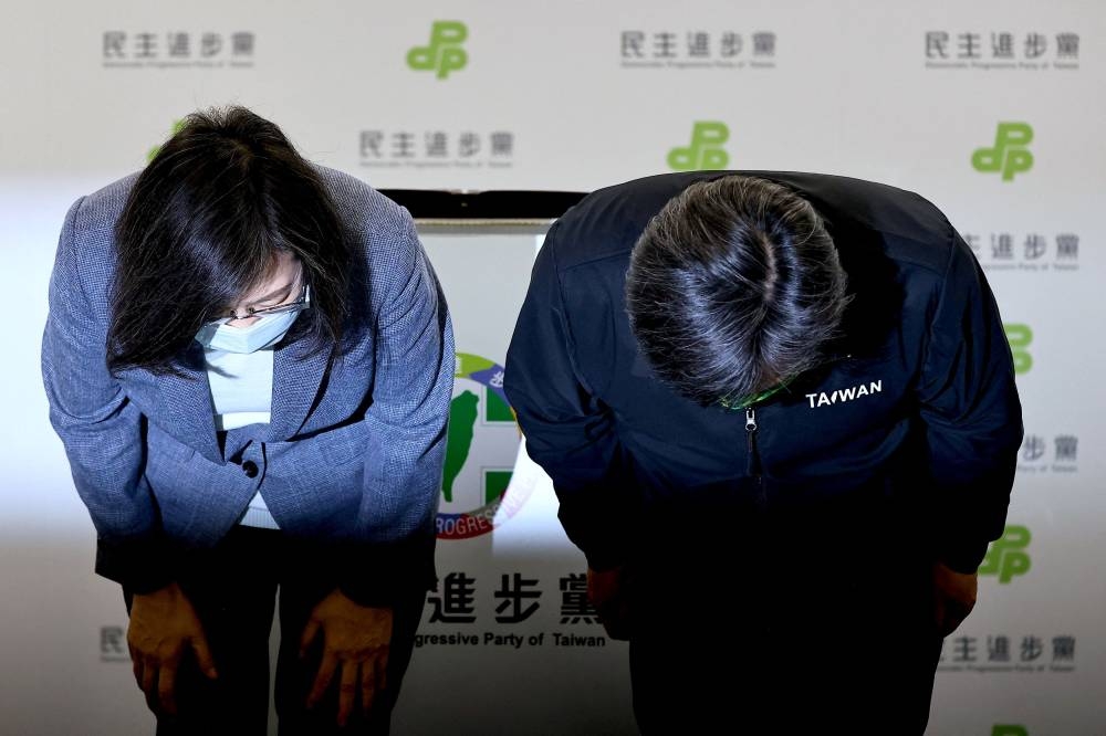 Taiwanese President Tsai Ing-wen bows as she announces to resign as Democratic Progressive Party chair to take responsibility for the party’s performance in the local elections in Taipei, Taiwan, November 26, 2022. ― Reuters pic