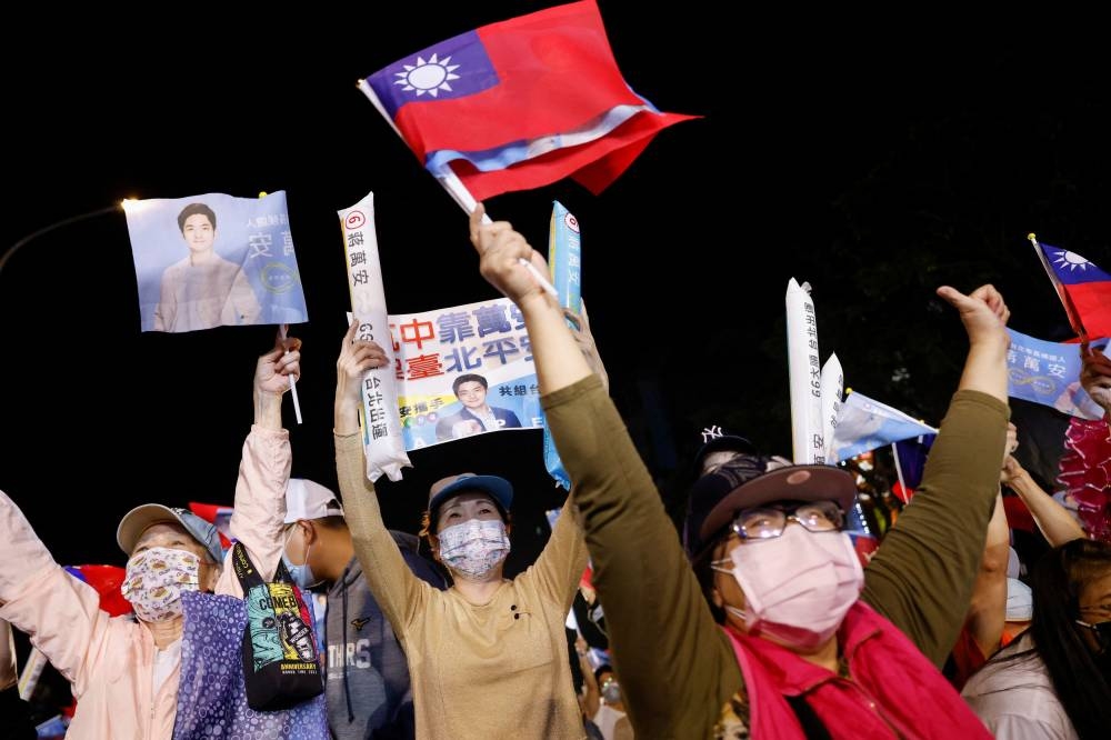 Supporters of the opposition party Kuomintang (KMT) celebrate the preliminary results of the local elections during a rally in Taipei November 26, 2022. — Reuters pic