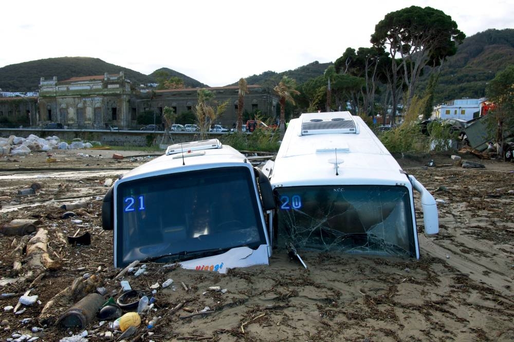Damaged tourist buses are seen on the port of Casamicciola on November 27, 2022, following heavy rains that caused a landslide on the island of Ischia, southern Italy. — AFP pic