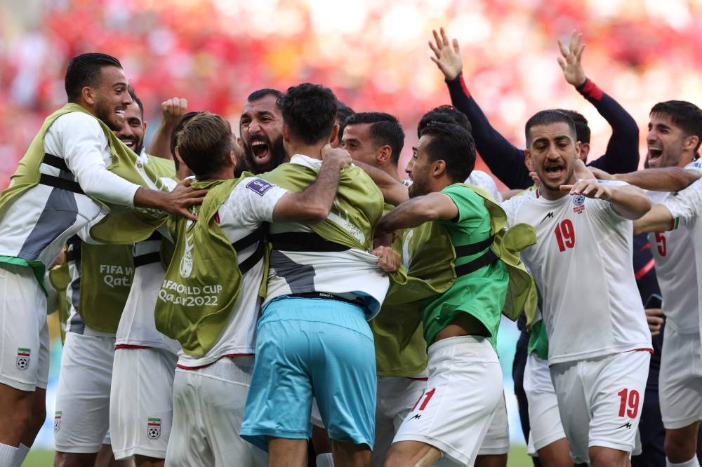Iran’s defender Roozbeh Cheshmi (back, centre) celebrates scoring his team’s first goal during the Qatar 2022 World Cup Group B match between Wales and Iran at the Ahmad Bin Ali Stadium in Al-Rayyan, west of Doha, November 25, 2022. — AFP pic 