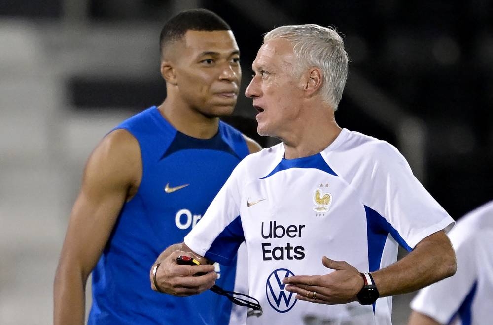 France’s coach Didier Deschamps reacts next to France’s forward Kylian Mbappe during a training session at Jassim-bin-Hamad Stadium in Doha, November 28, 2022. — AFP pic 