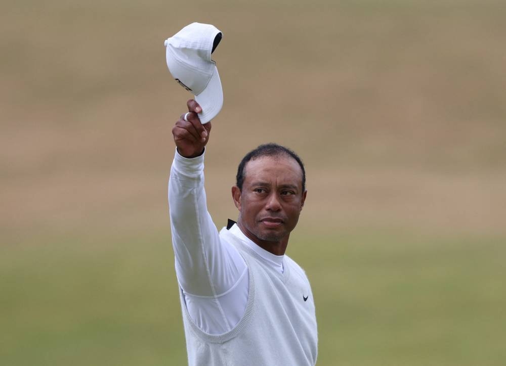 Tiger Woods of the U.S. acknowledges the fans after holing on the 18th and finishing his second round at the 150th Open Championship at St Andrews, Scotland July 15, 2022. — Reuters pic