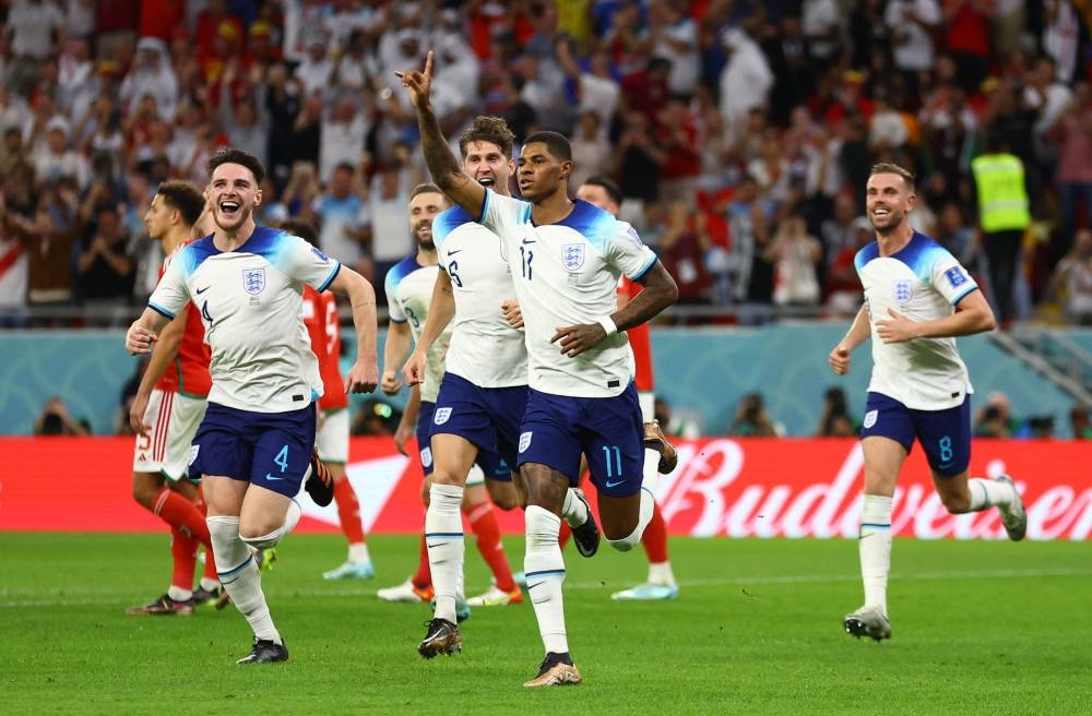 England's Marcus Rashford celebrates scoring their first goal against Wales at the Ahmad Bin Ali Stadium, Al Rayyan November 29, 2022. — Reuters pic