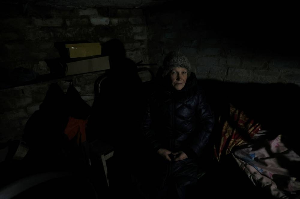 Ludmila Syabro, 61, sits for a portrait in the storage cellar where she and her husband Victor, 68, sleep, despite the fact that their home was mostly destroyed by shelling in the summer and their garden was hit as recently as last week as the town continues to receive shelling on a daily basis in Siversk, Donetsk region, Ukraine November 28, 2022.  — Reuters pic