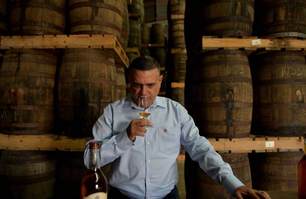 In this file photo taken on March 09, 2018, Cuban rum master Asbel Morales tastes Havana Club rum, at the Havana Club's San Jose distillery, in San Jose de las Lajas, Mayabeque province, Cuba. — AFP pic