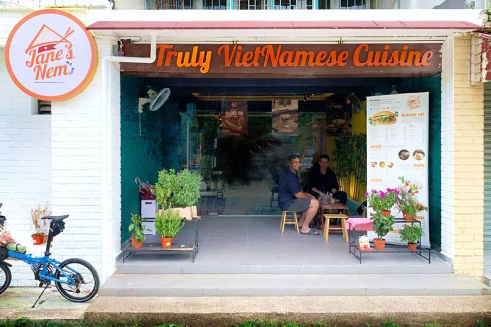 The shop can be identified by its logo emblazoned with the traditional Vietnamese headgear, a conical 'nón lá' hat.