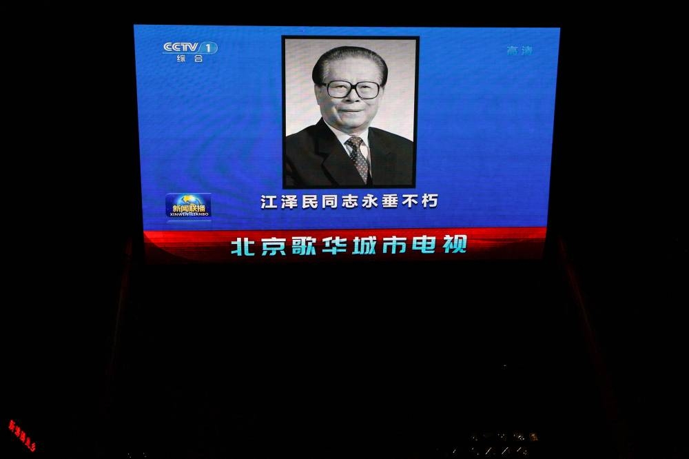 A screen broadcasts news footage of former Chinese President Jiang Zemin following his death, in Beijing, China November 30, 2022. — Reuters pic